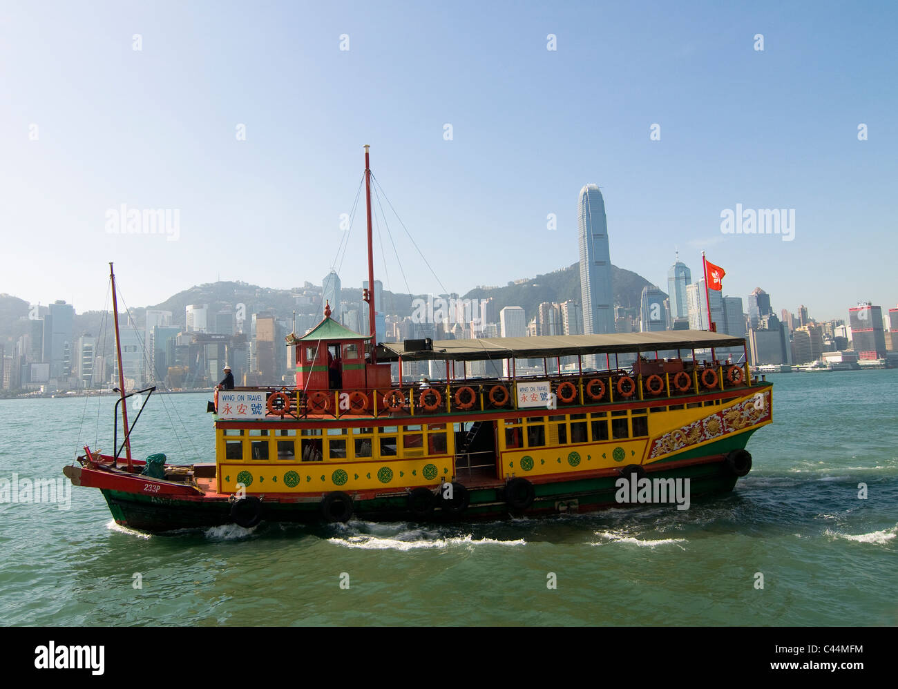 An old boat crossing Victoria harbor in Hong Kong. Stock Photo