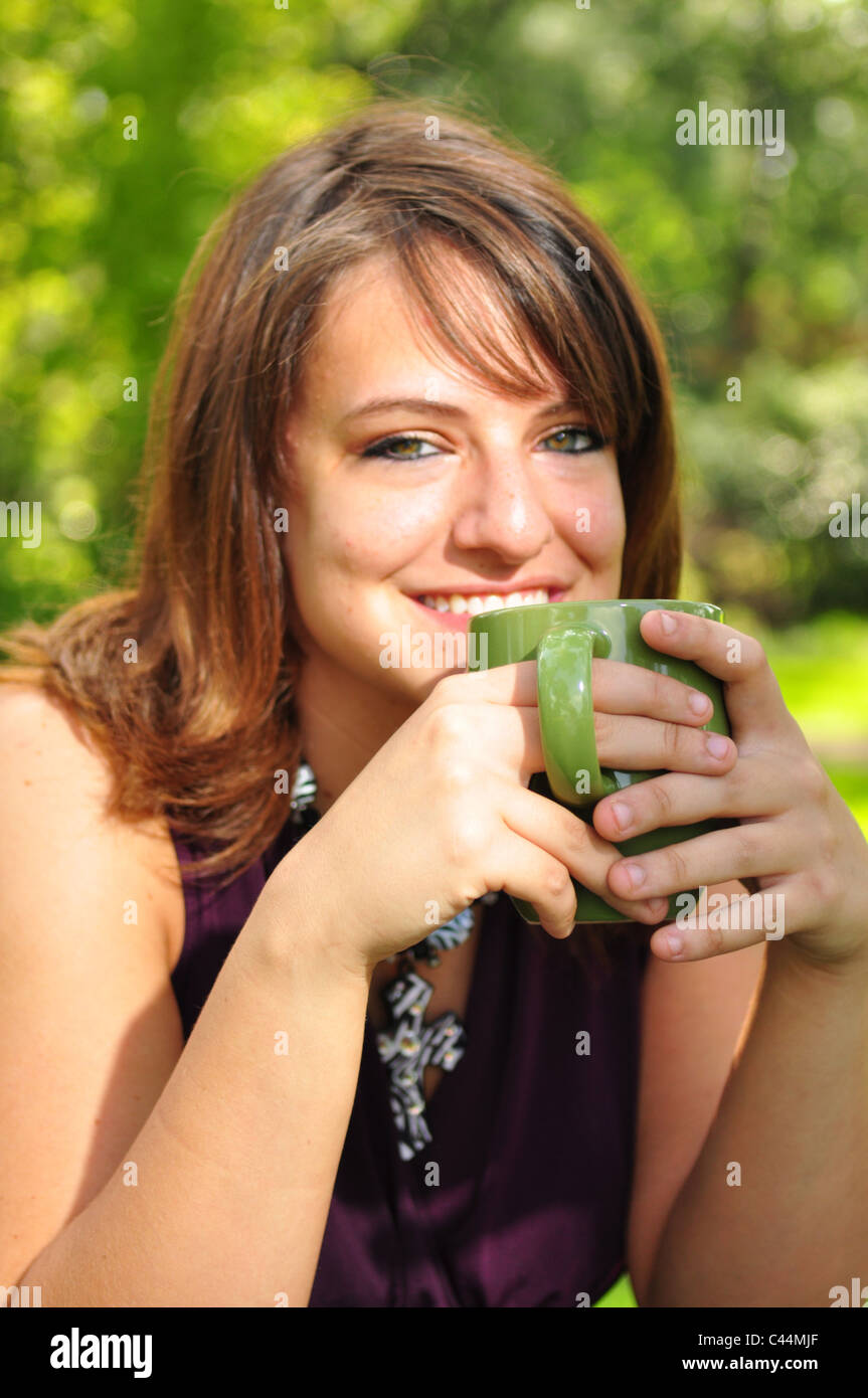 A young woman is relaxing outdoors Stock Photo