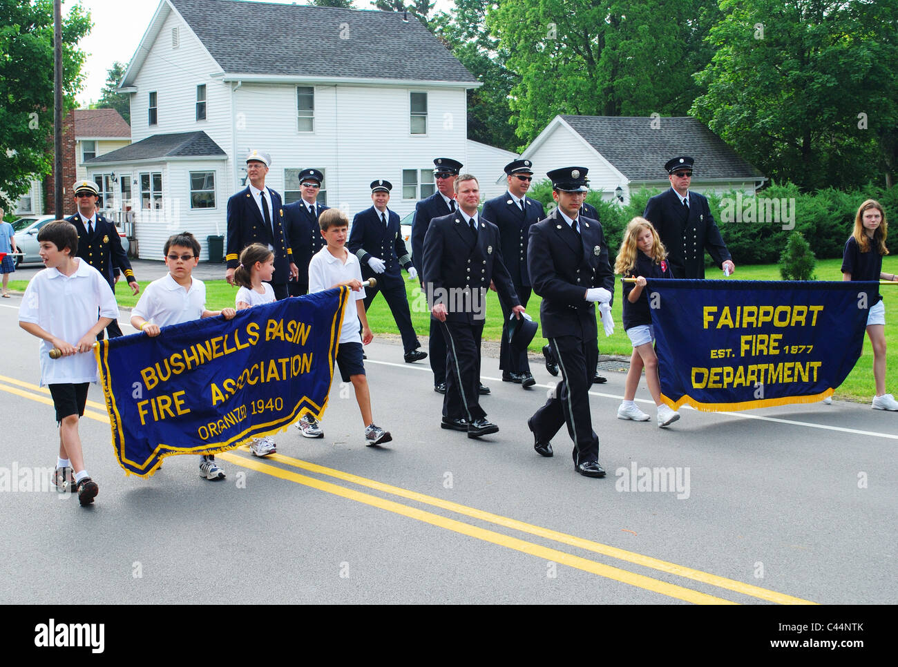 Firemen and children with banners. Stock Photo