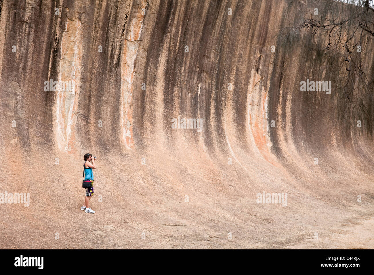 Tourist at Wave Rock a natural rock formation near Hyden, Western Australia, Australia Stock