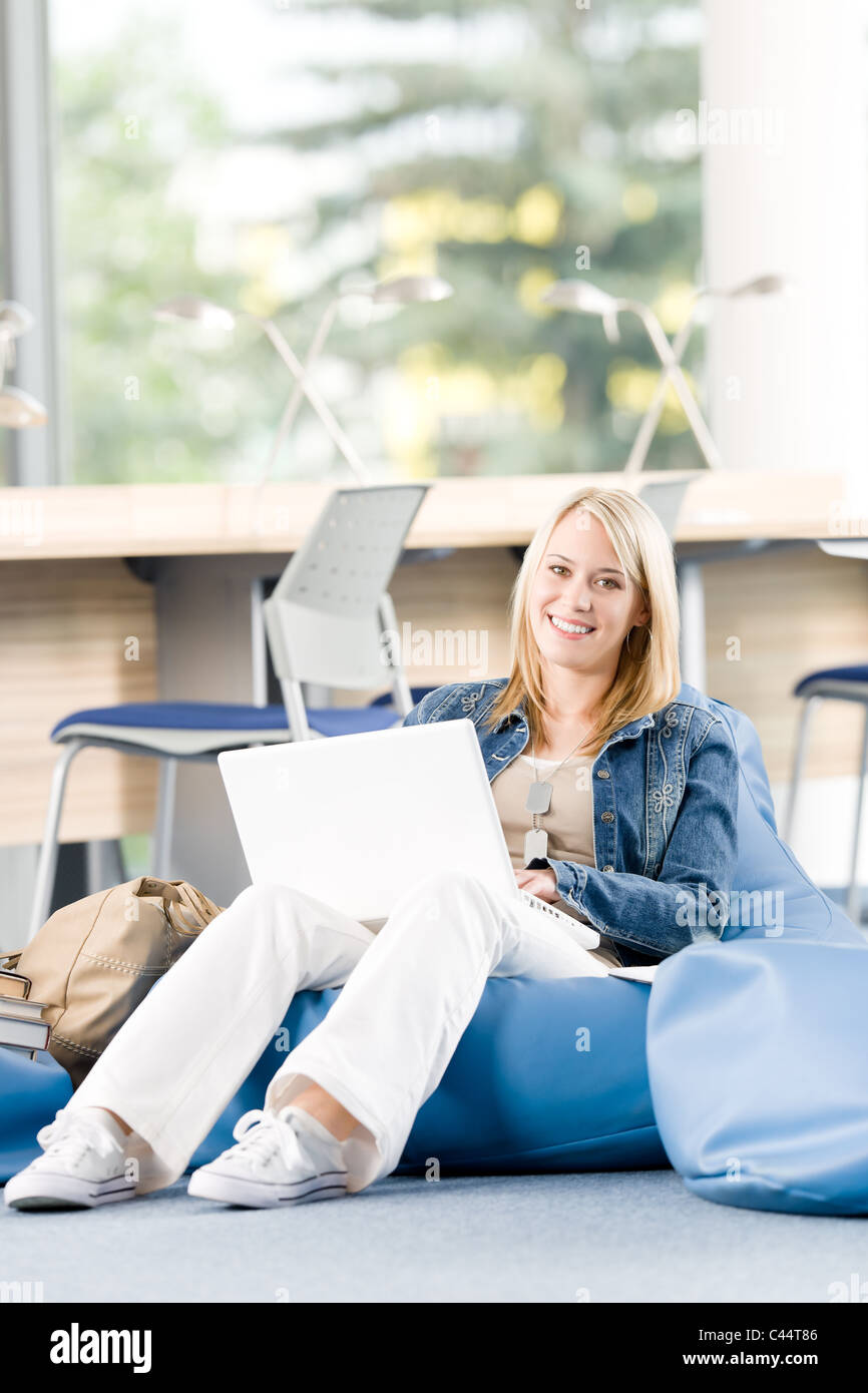 Young happy student girl relaxing at high school with laptop Stock ...