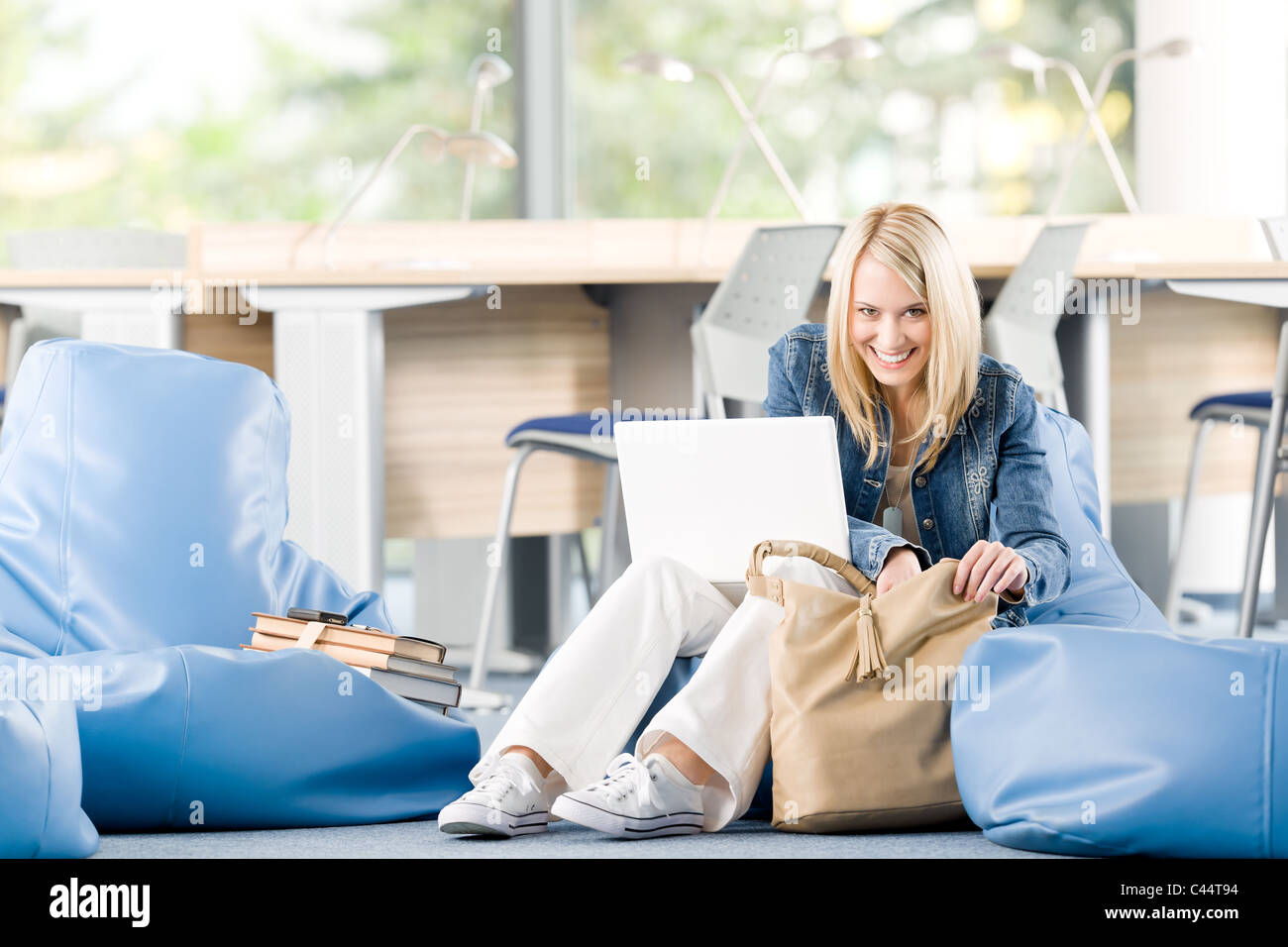 Young happy student girl relaxing at high school with laptop Stock ...