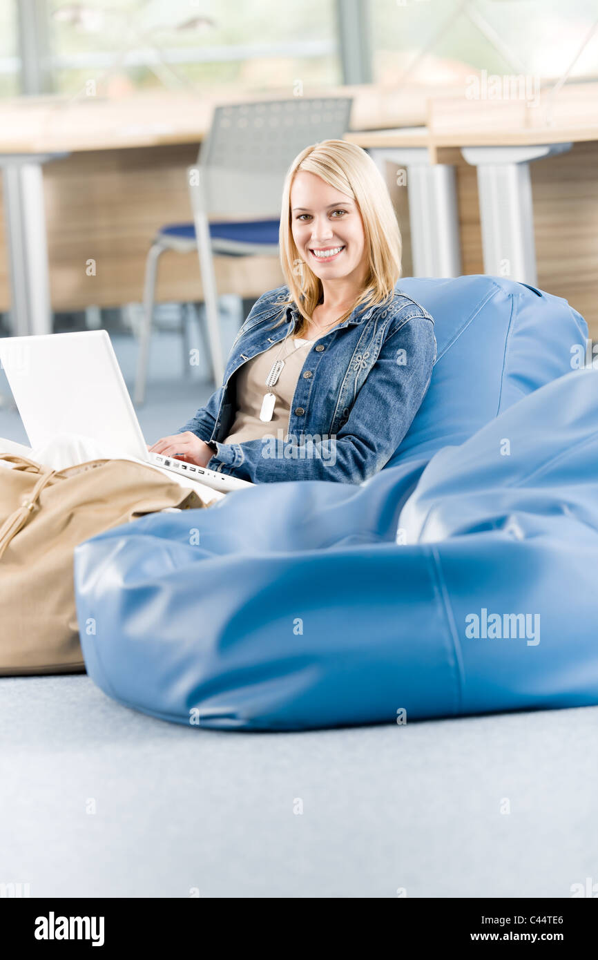 Young happy student girl at high school relaxing with laptop Stock ...