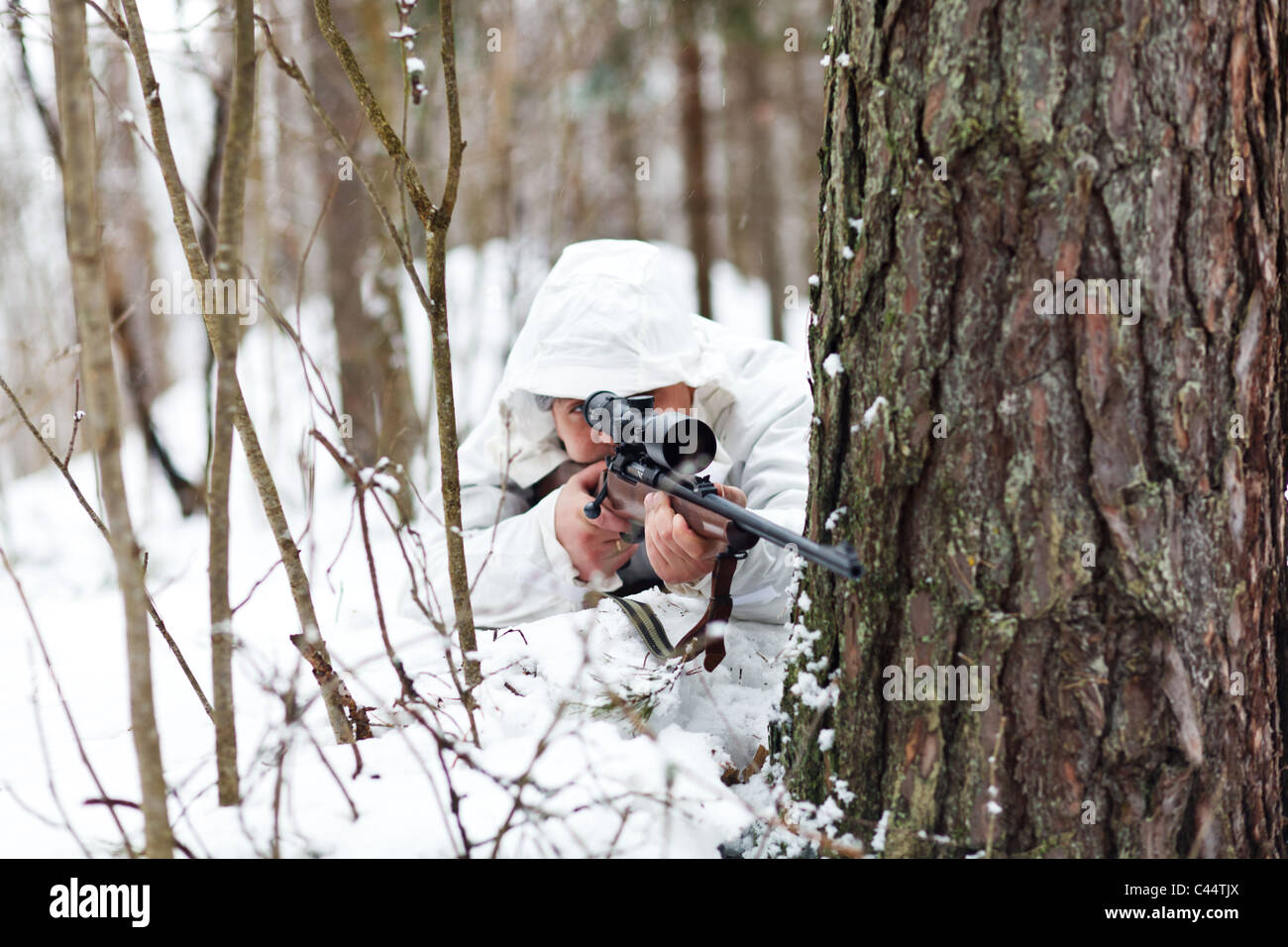 A Camouflaged Sniper Sitting In The Woods Aiming Through His Scope Stock  Photo, Picture and Royalty Free Image. Image 42659284.