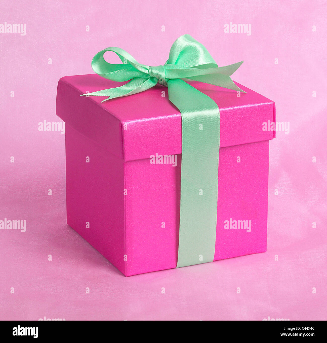 Pink box with green ribbon, close-up Stock Photo