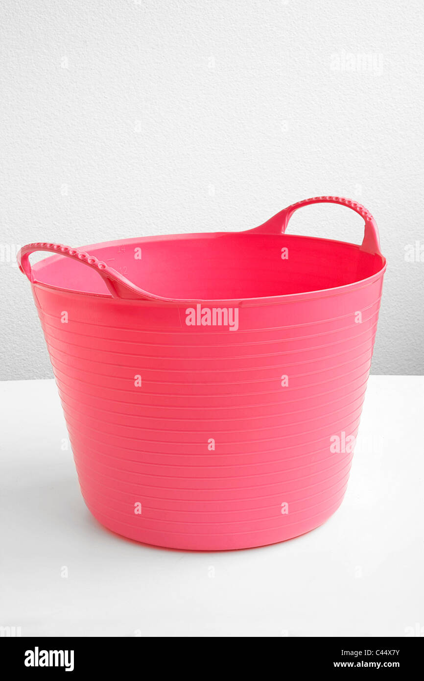Pink plastic laundry basket, closeup Stock Photo Alamy