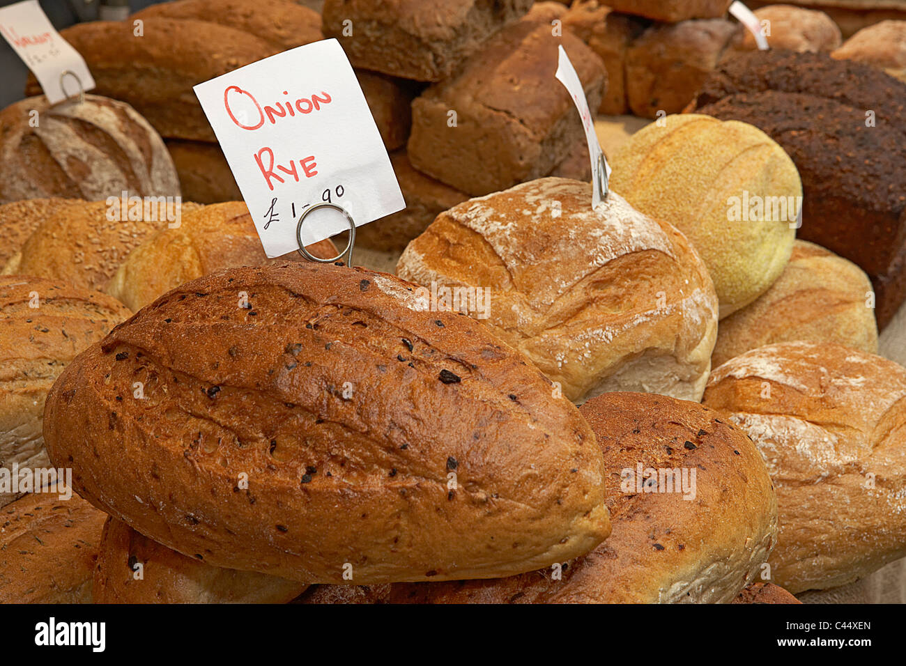 UK, Onion rye bread, wholemeal and white organic loaves in bakery