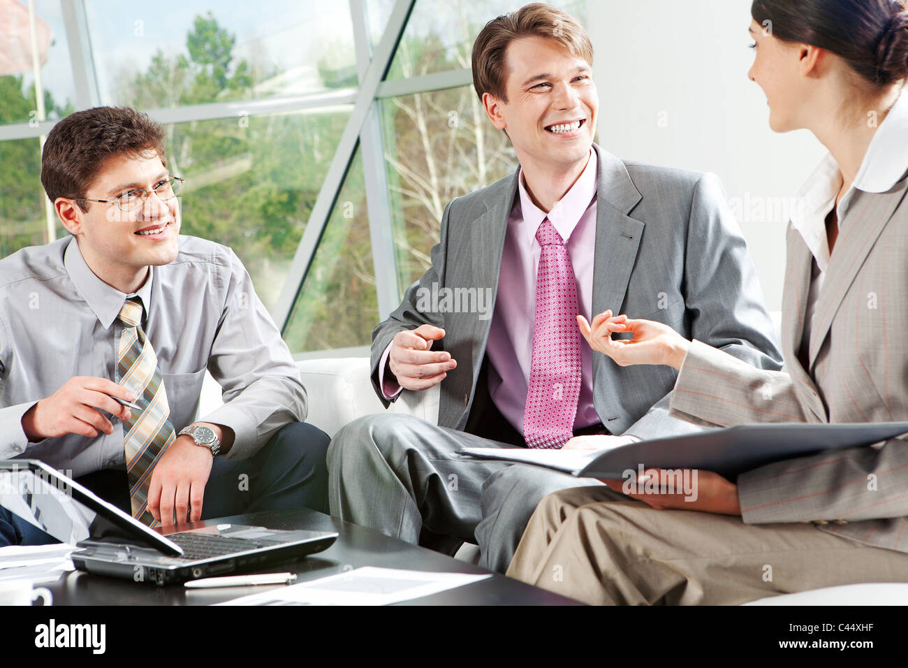 Been Discussing Smiling friends discussing documents hi-res stock photography and ...
