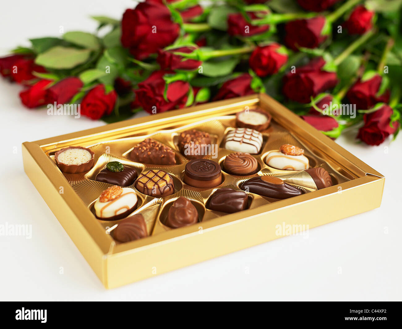 Box of chocolates and red roses, close-up Stock Photo