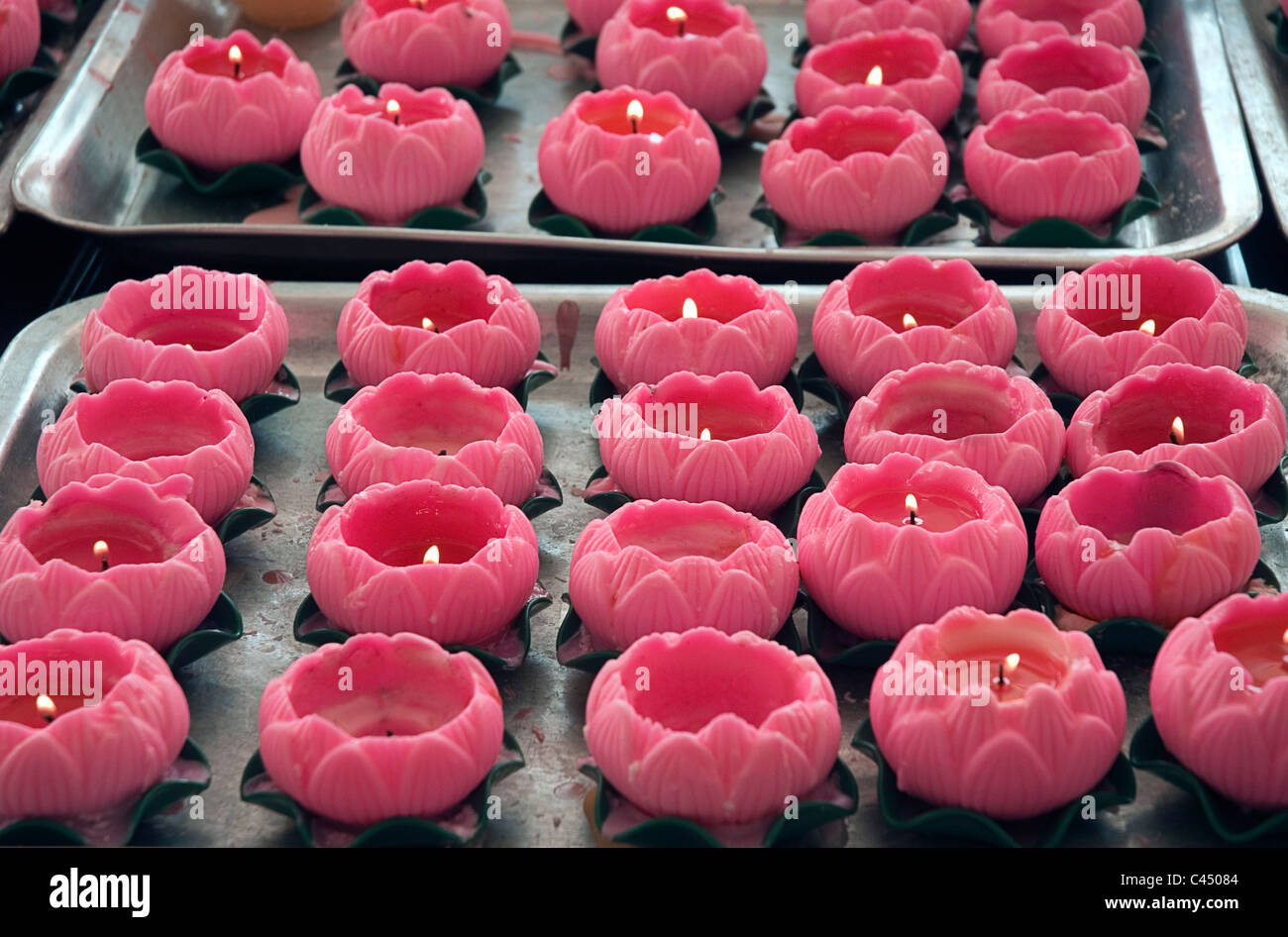 Malaysia, Kuala Lumpur, Thean Hou Temple, pink lotus-shaped candles on trays, close-up Stock Photo