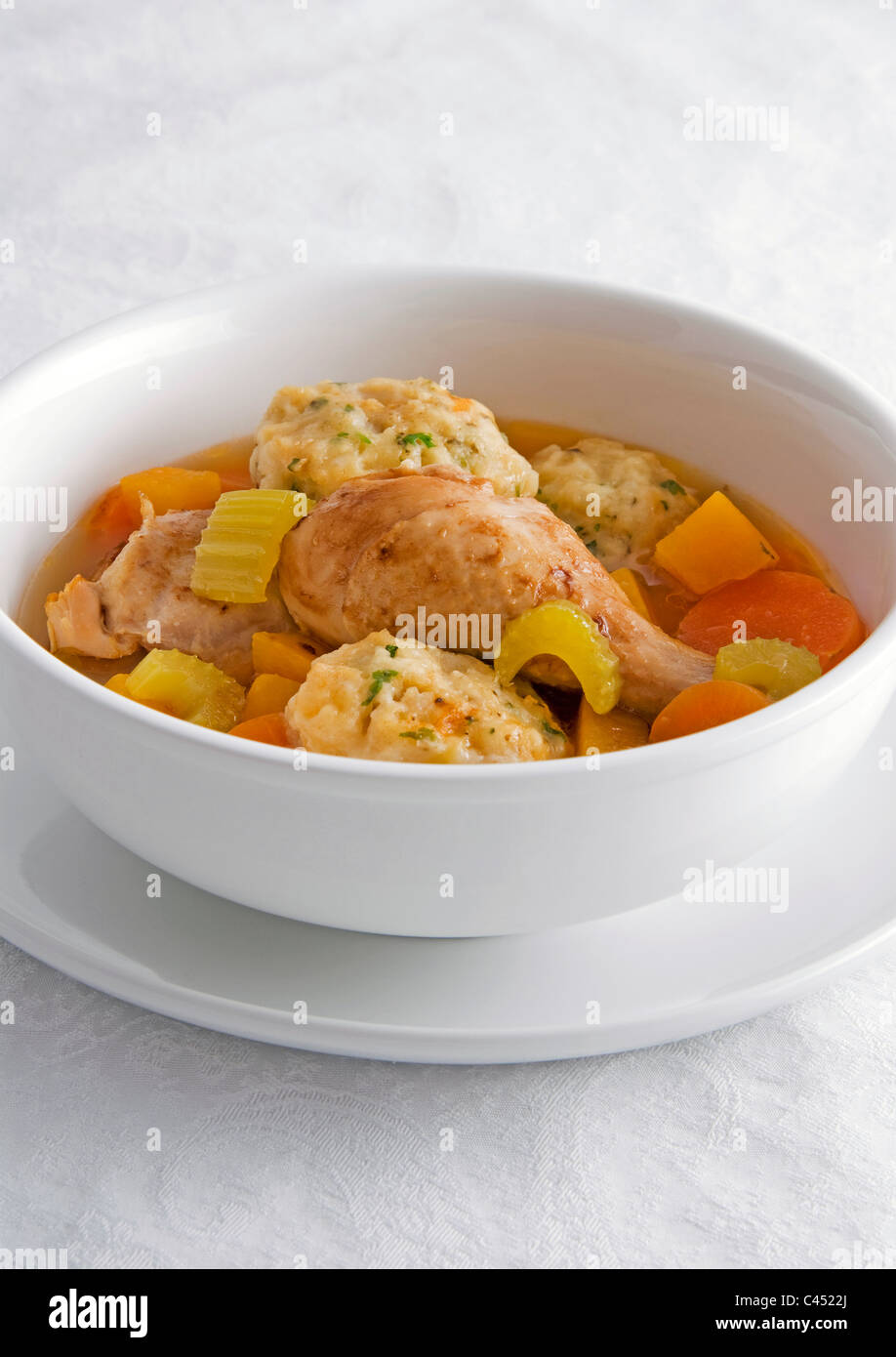 Chicken herb dumplings in bowl, close-up Stock Photo