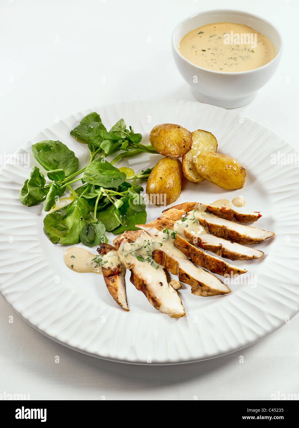 Lemon honey chicken with mustard mayonnaise on plate, closeup Stock