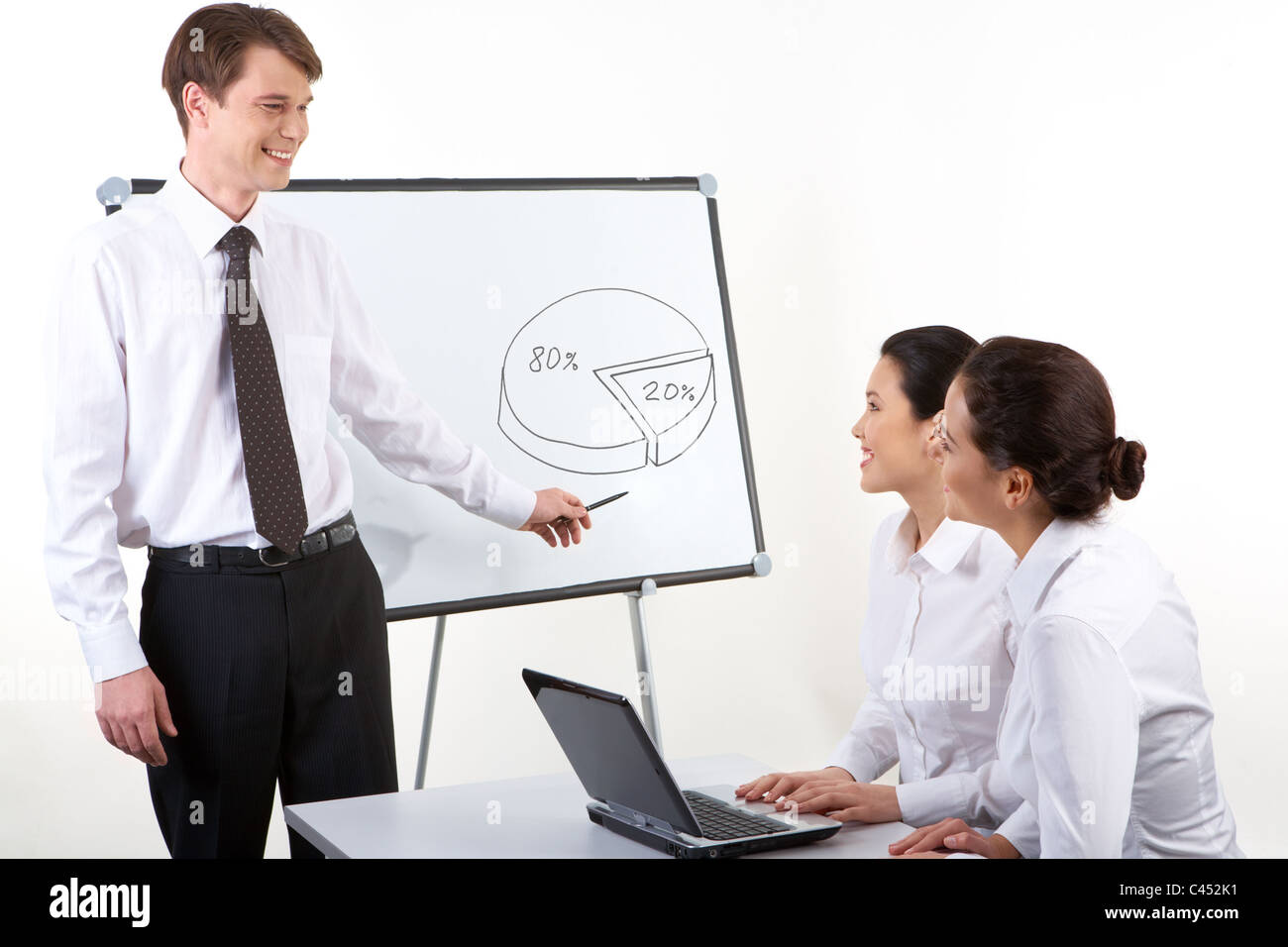 Photo of happy man commenting diagram to his colleagues who sitting at ...