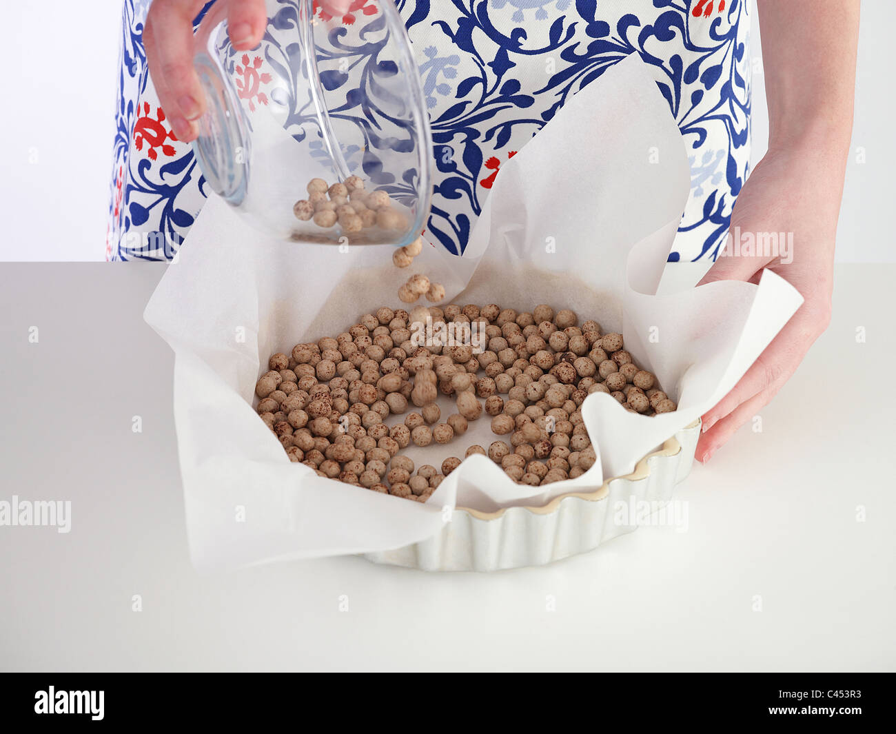 Woman pouring baking beans on tart hires stock photography and images