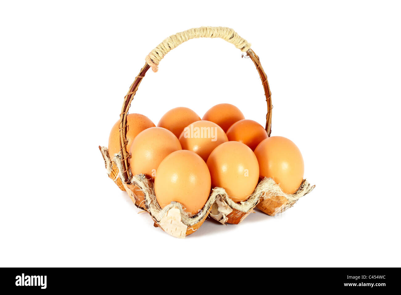 Chicken eggs in a basket made of natural materials, isolated Stock Photo