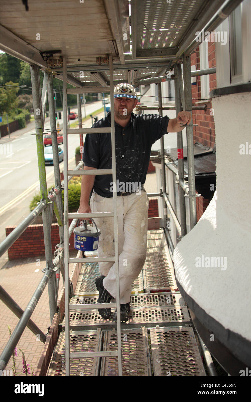 painter and decorator on scaffolding Stock Photo - Alamy