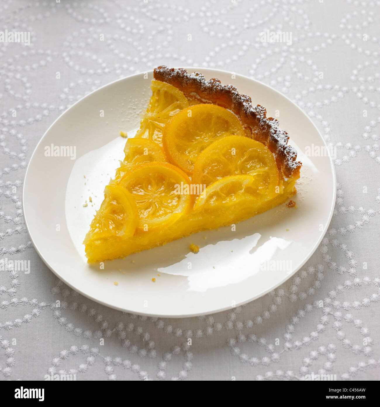 Slice of lemon tart on plate, close-up Stock Photo