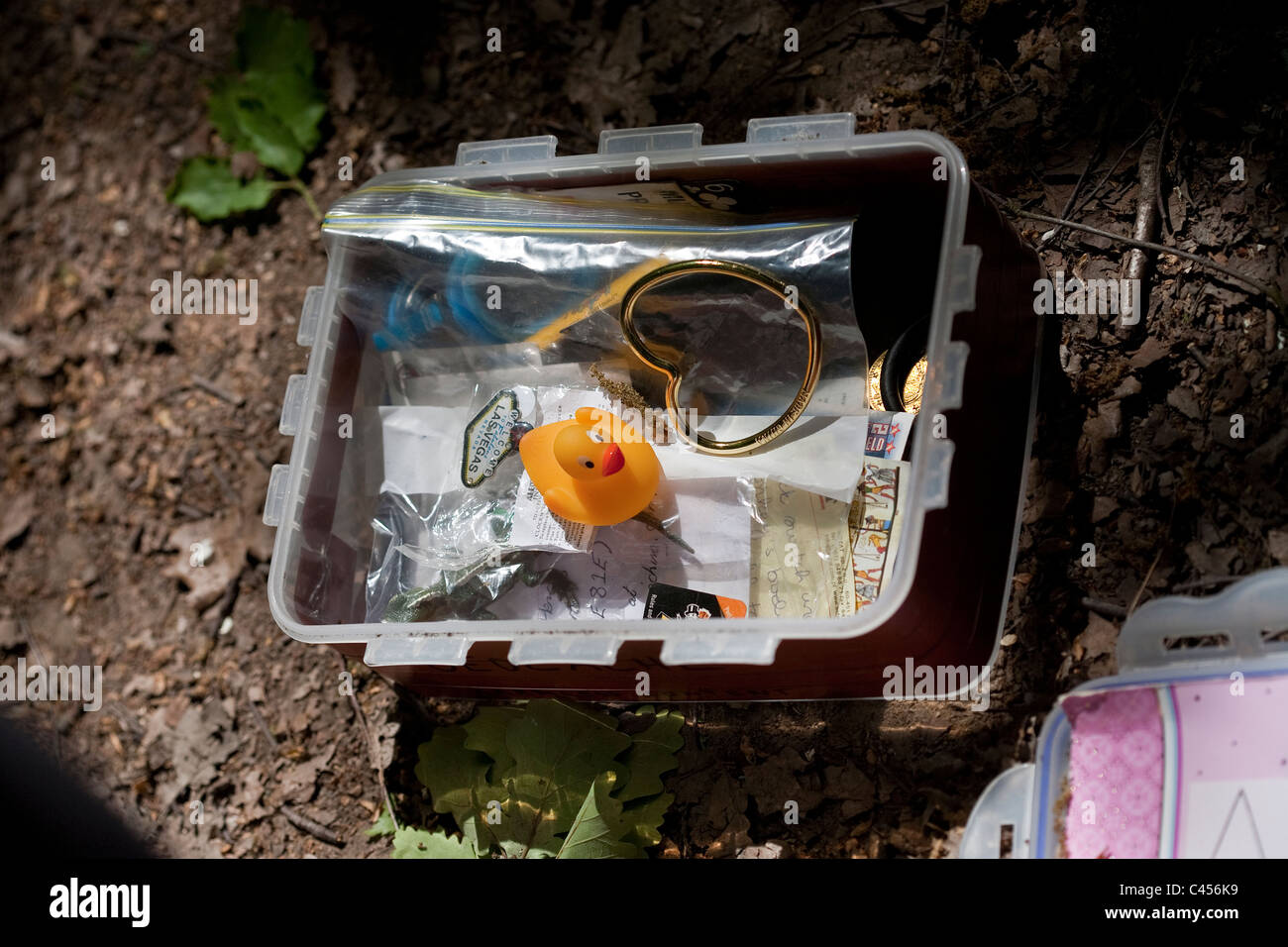 An open geocache box showing contents Stock Photo Alamy