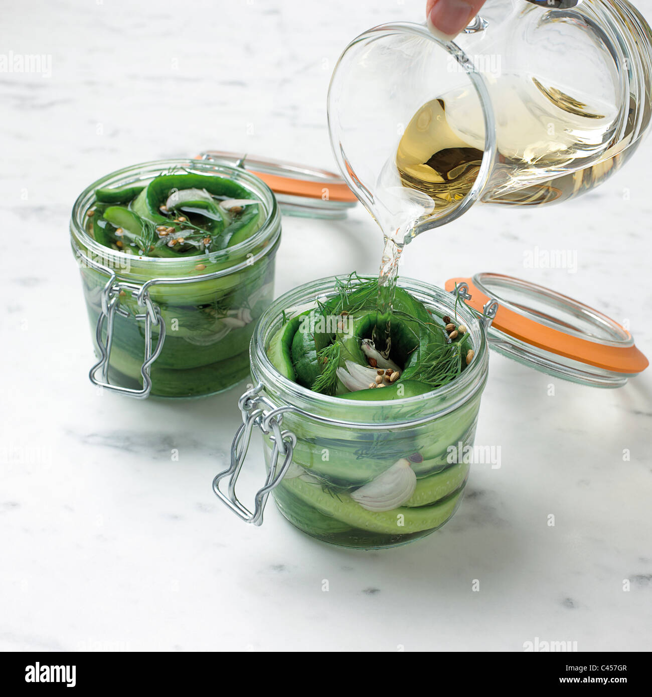 Pouring vinegar onto cucumber in jars, closeup Stock Photo Alamy