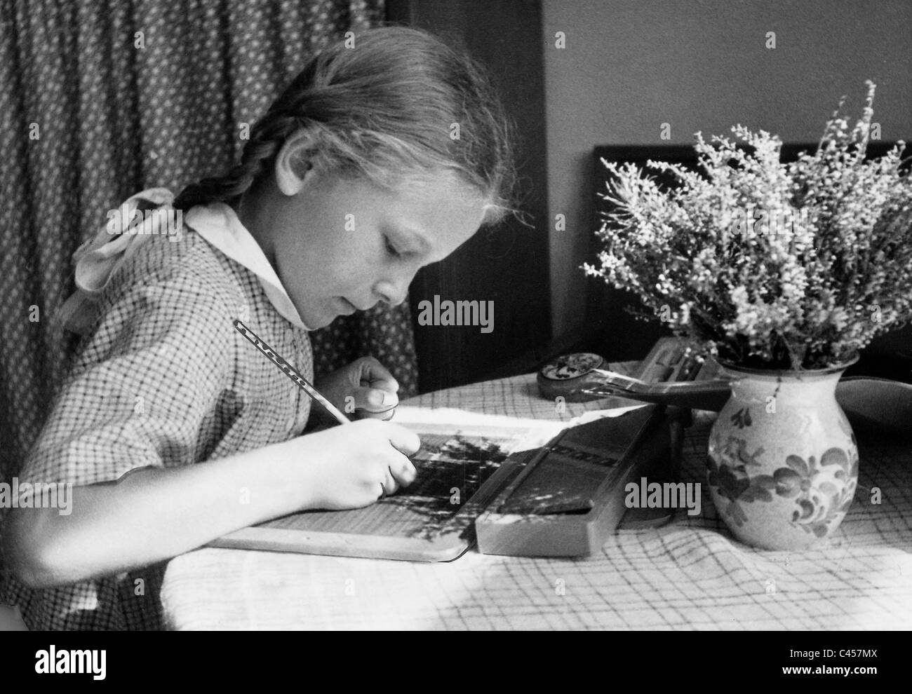 Female student doing her homework, 1941 Stock Photo
