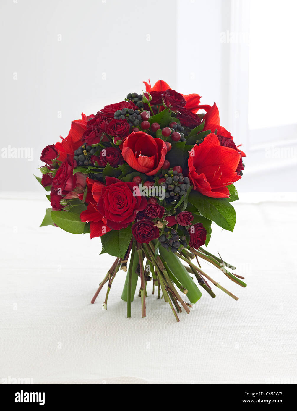 Bunch of flowers including roses, amaryllis, hypericum, berries, close-up Stock Photo