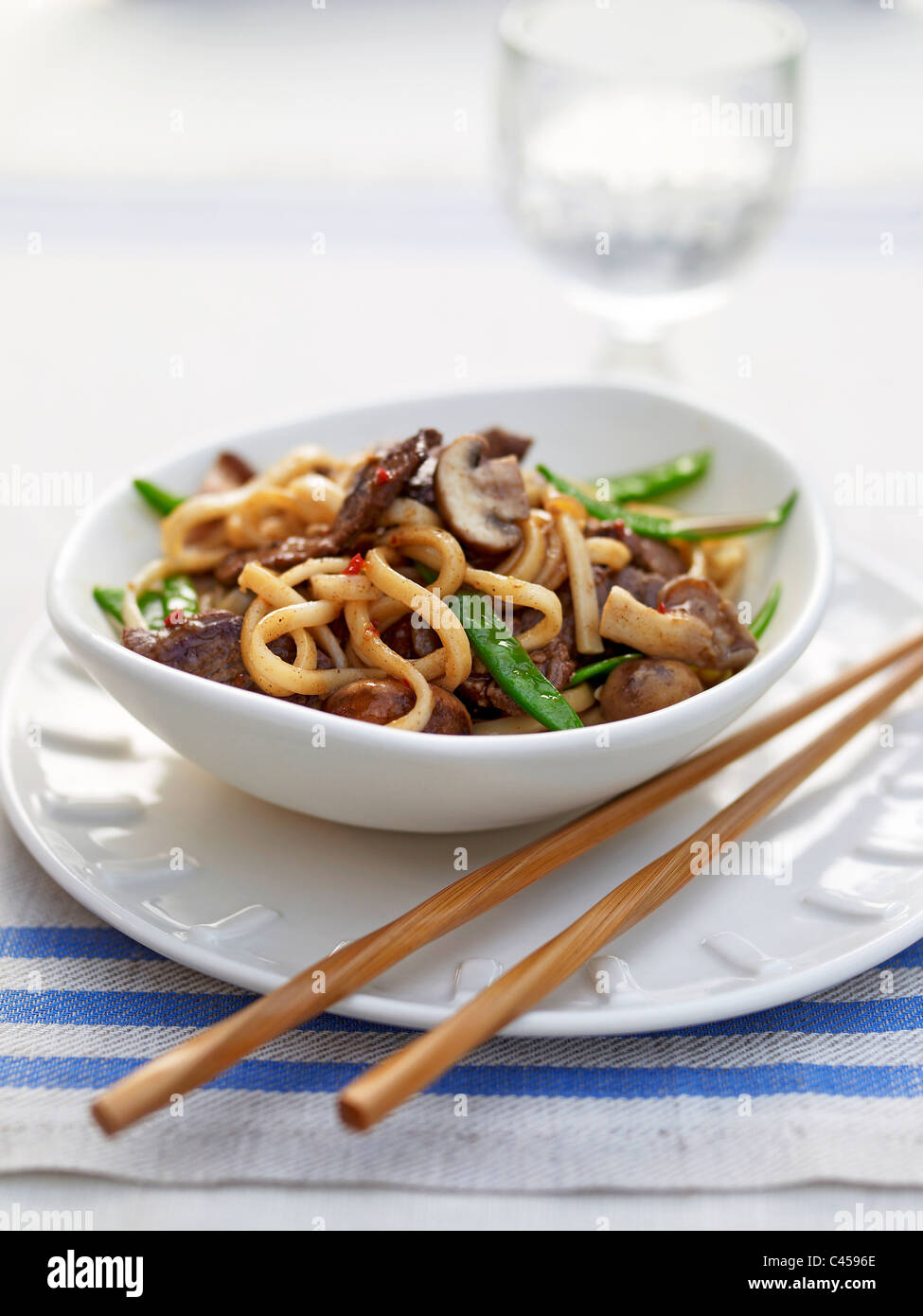 Bowl of ginger beef noodles on plate, close-up Stock Photo