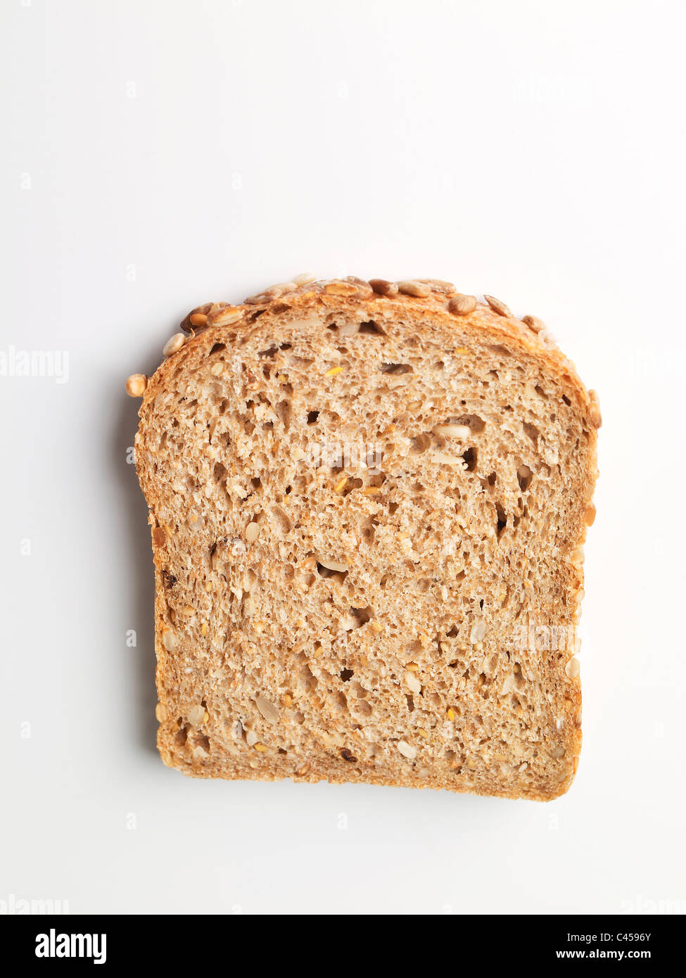 Slice of wholemeal bread on white background, close-up Stock Photo