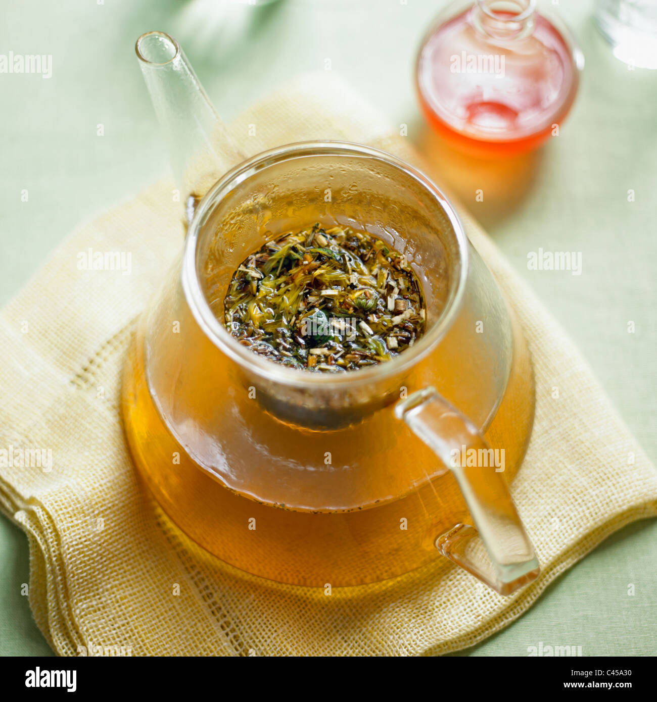 Marigold and peppermint herbal tea in tea pot, close-up Stock Photo