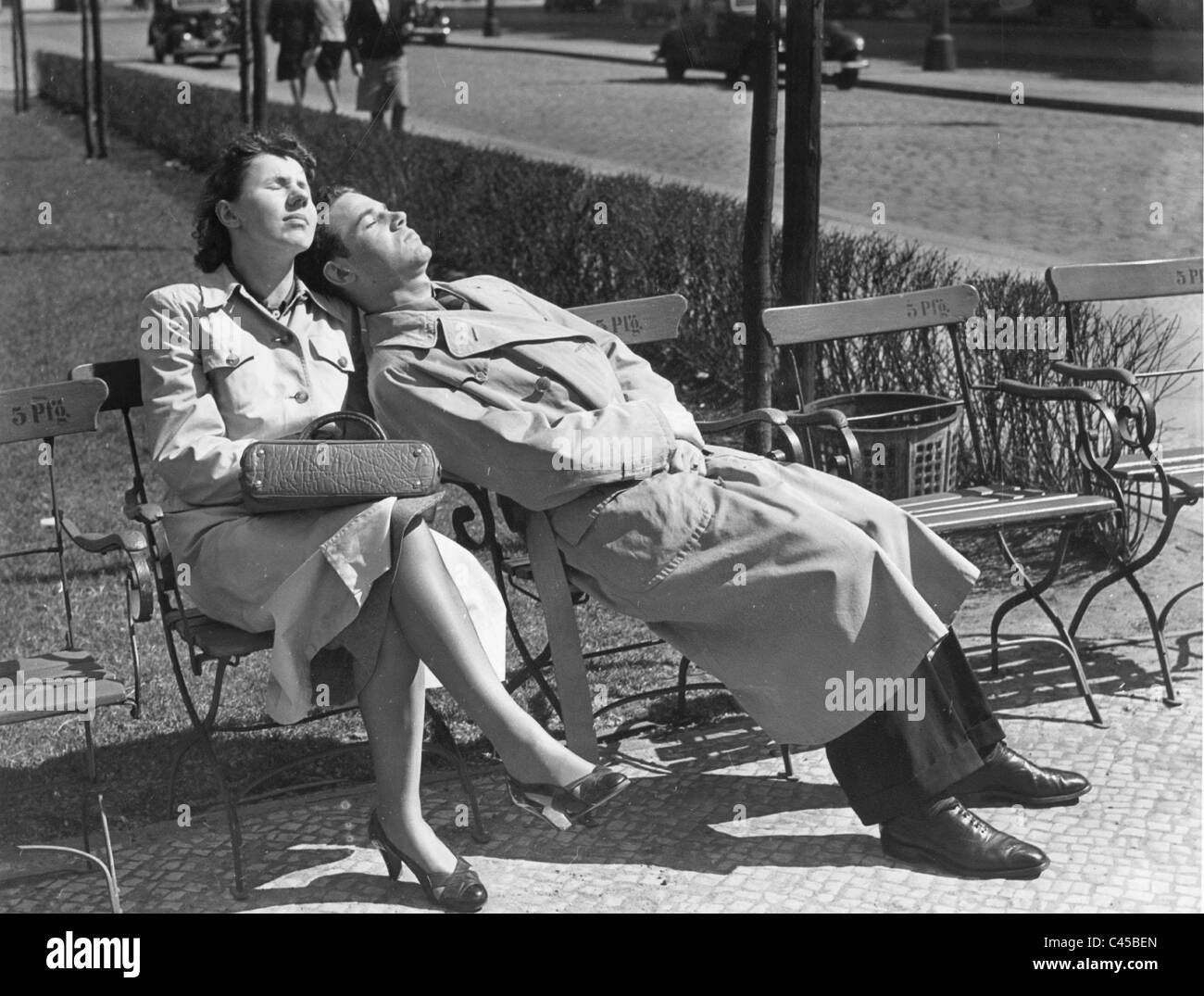 A couple sunbathing in a park, 1940 Stock Photo