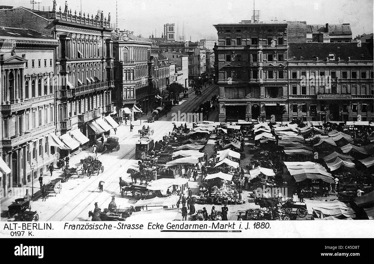 Market stalls and horse drawn carriages on the Gendarmen Market. Stock Photo