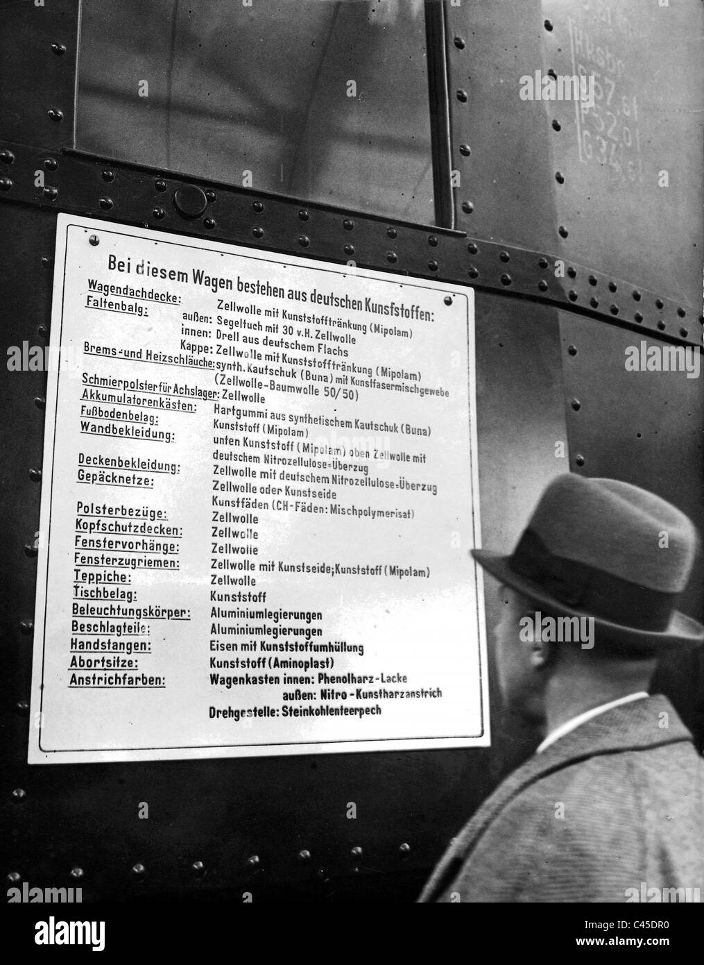 Viewer in front of a table that reveals the usage of the plastic manufactured in Germany Stock Photo