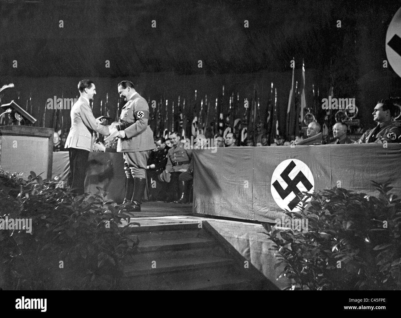Goebbels presents Goering with a Party badge of honor after the announcement of the four year plan Stock Photo