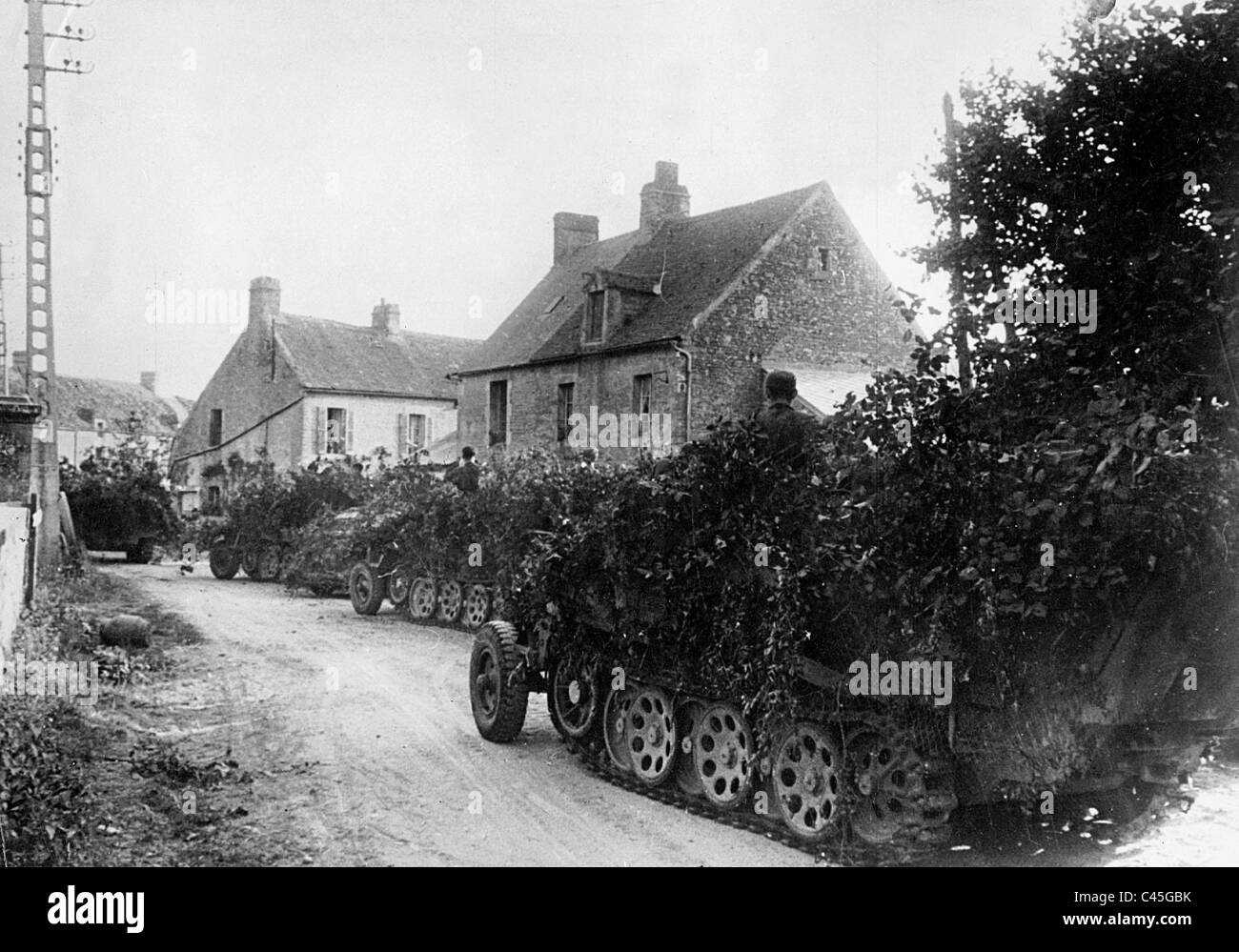 German armored vehicles in a village in France, 1944 Stock Photo