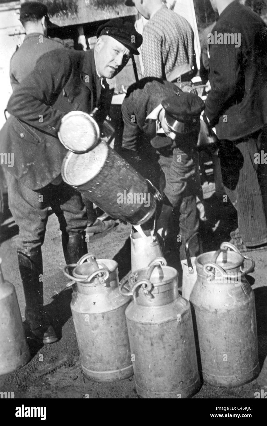 Serbian forced laborers in Germany get a milk ration, 1942 Stock Photo ...