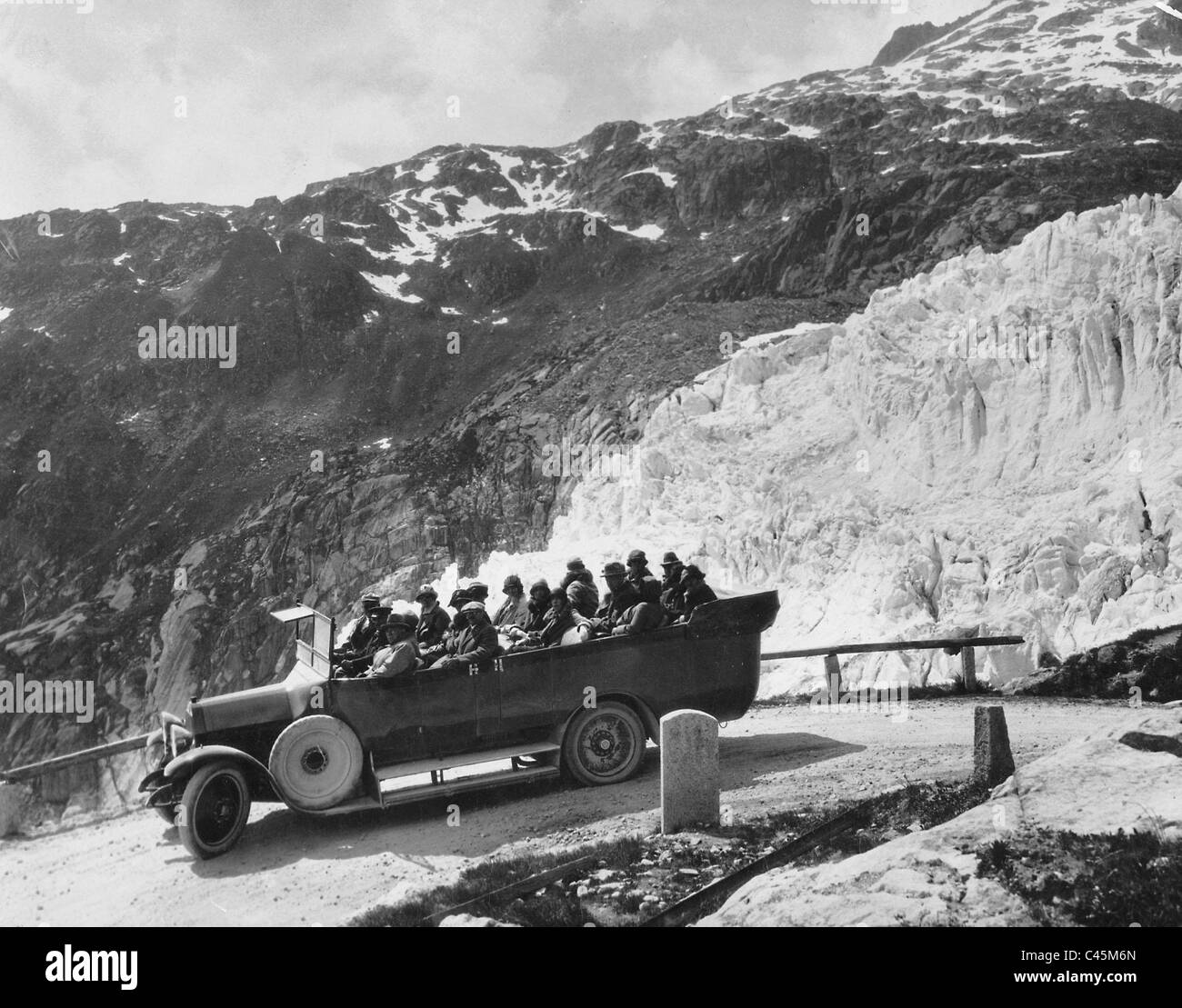 Bus on a Swiss mountain road Stock Photo