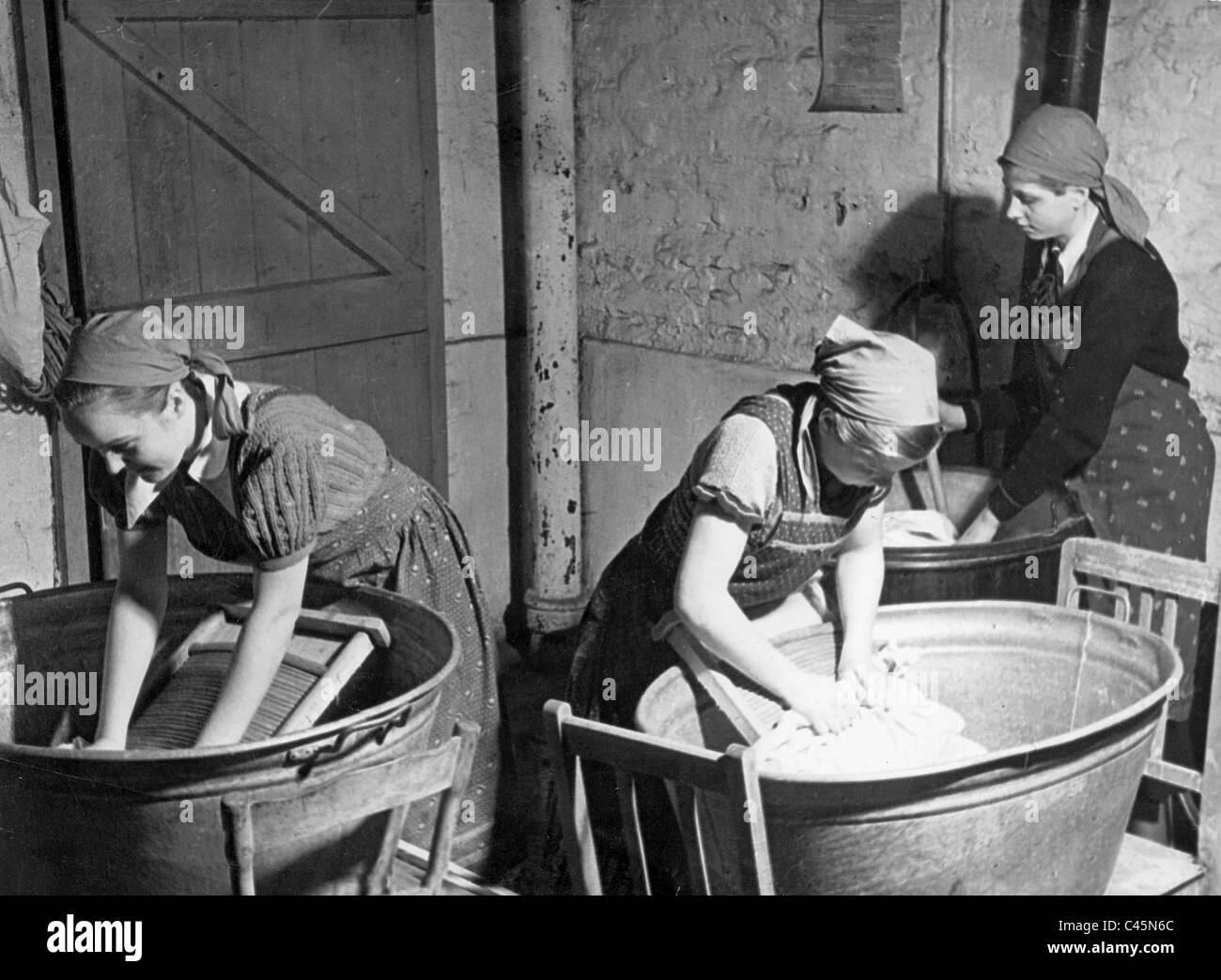 Girls doing laundry, 30's Stock Photo Alamy