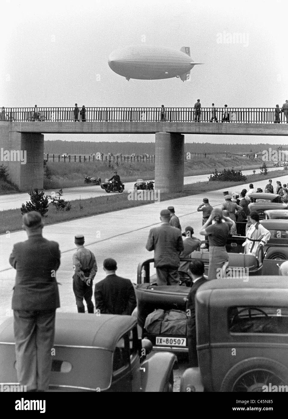 Airship LZ 129 'Hindenburg' near a highway, 1936 Stock Photo
