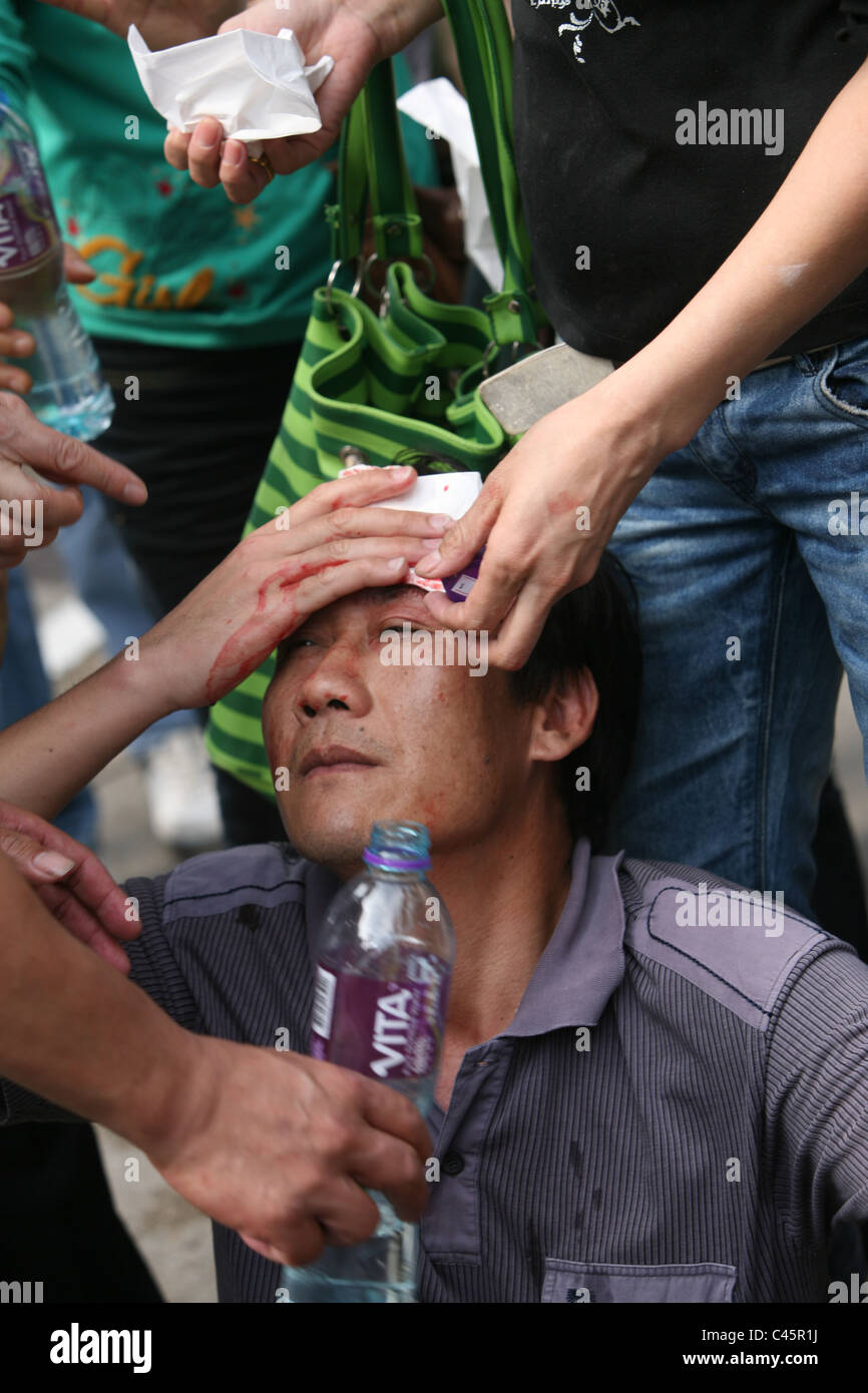 Man bleeding and hurt in a street protest, demonstration, Macau Stock Photo