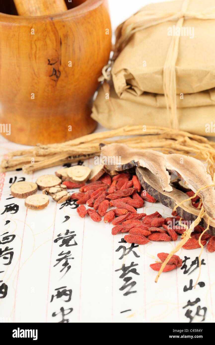 Ingredients for a Chinese medicine formula - Chinese characters are names for the herbs in the formula Stock Photo