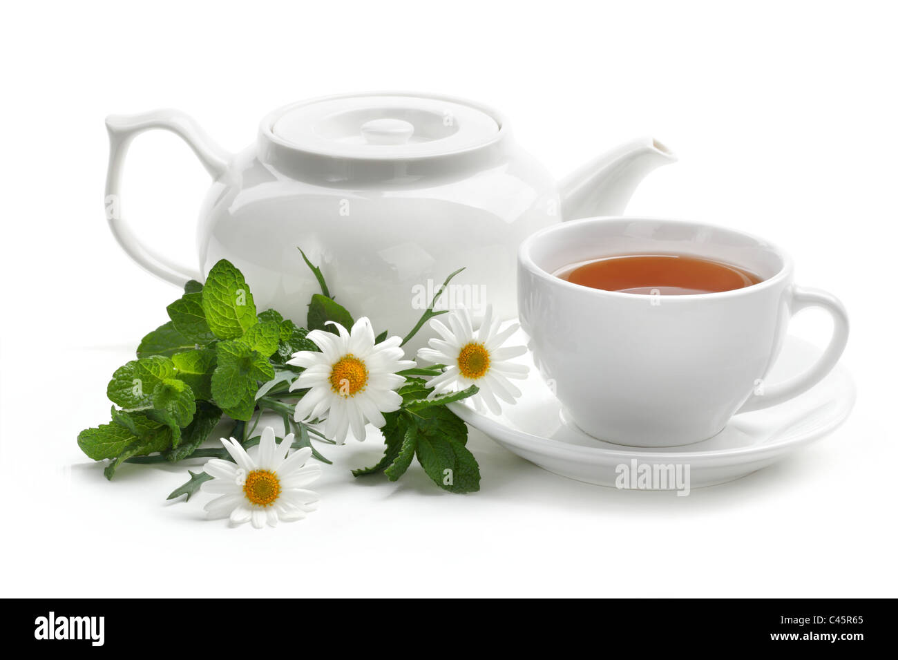 Black tea with fresh mint leaves and daisy. Isolated on white background. Stock Photo
