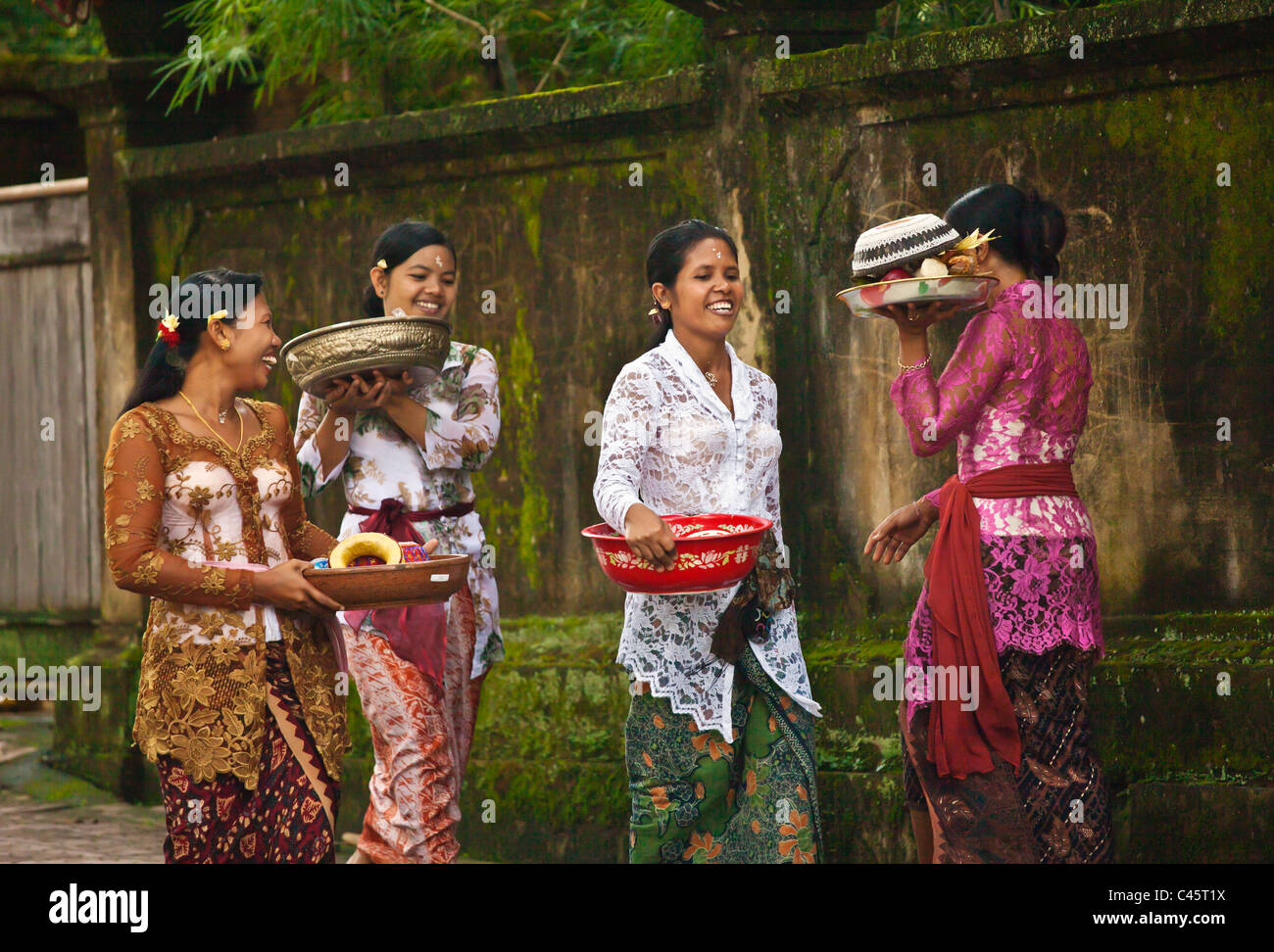 Women bring offerings at PURA TAMAN SARASWATI during the GALUNGAN FESTIVAL - UBUD, BALI, INDONESIA Stock Photo