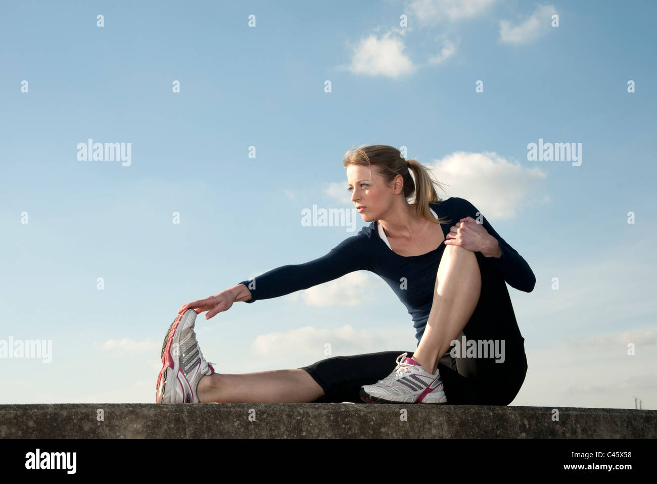 woman stretching muscles pre and post workout Stock Photo Alamy