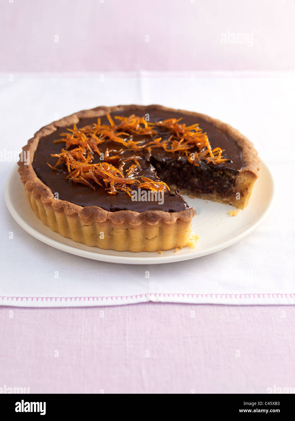 Nut-choc orange tart on plate, close-up Stock Photo
