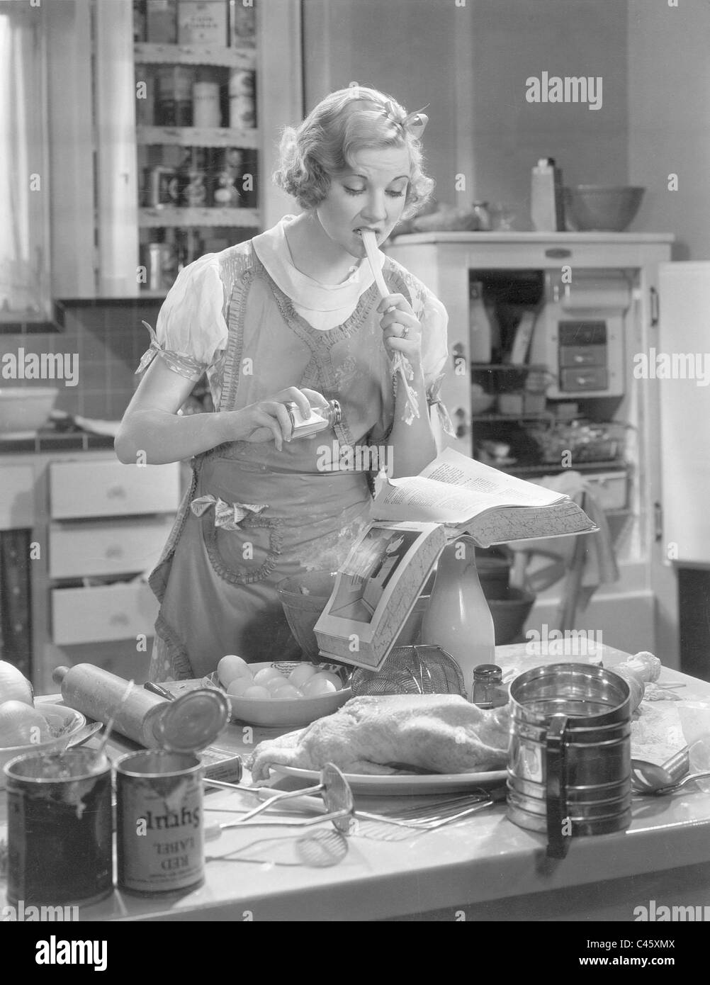 Una Merkel at a stove Stock Photo