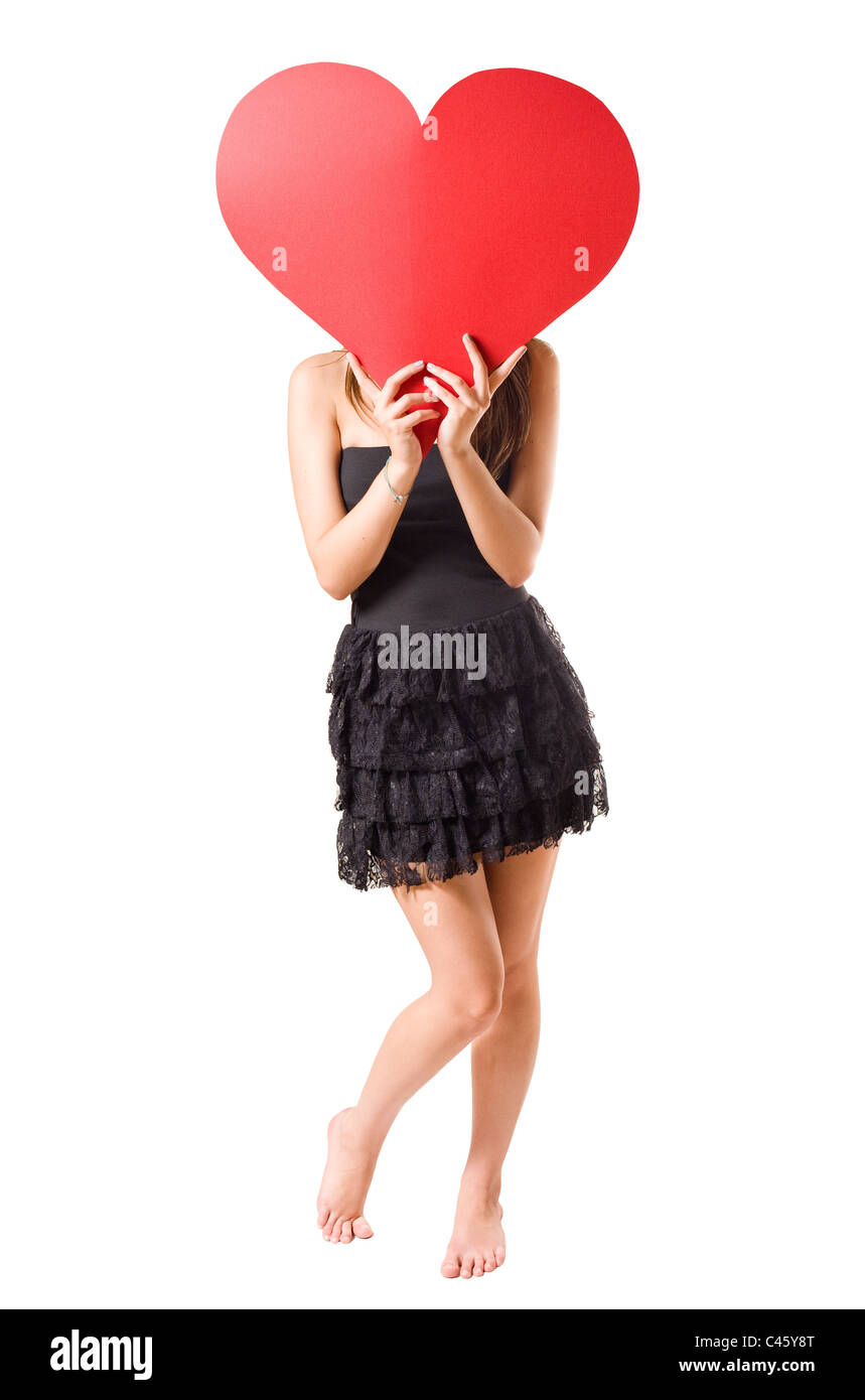 I love... beautiful young brunette girl holding big red heart, isolated ...