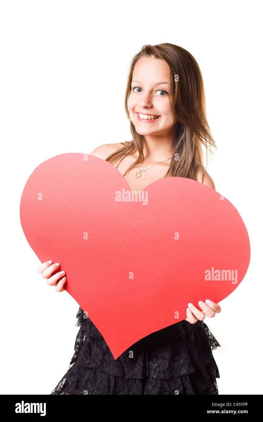 I love... beautiful young brunette girl holding big red heart, isolated ...