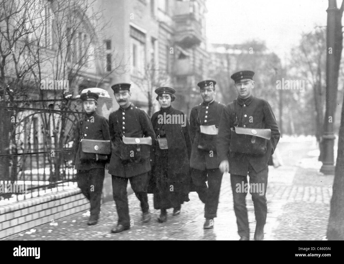 Postwoman with her male colleagues, 1916 Stock Photo