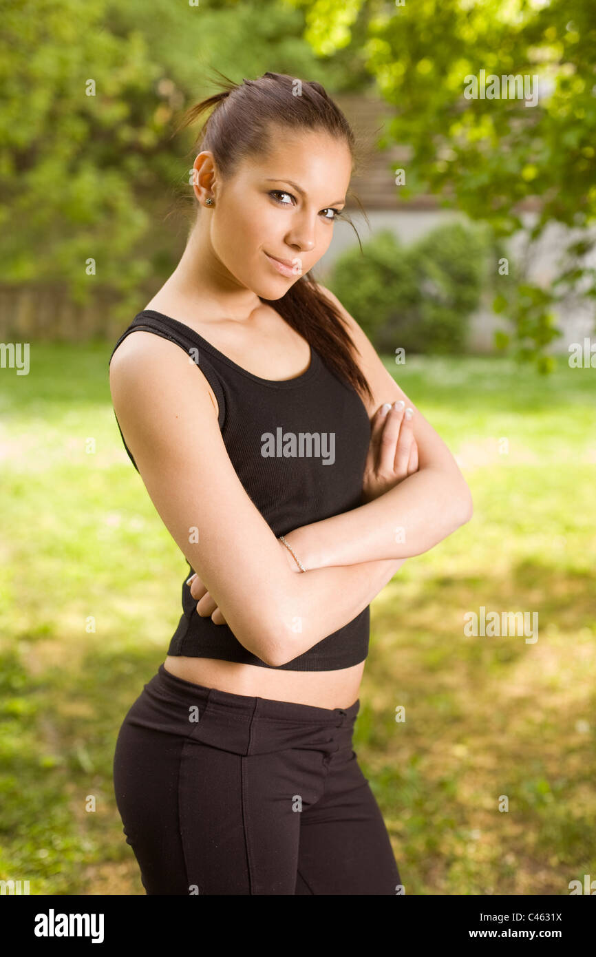 Gorgeous slim young fitness brunette posing outdoors in nature Stock Photo  - Alamy