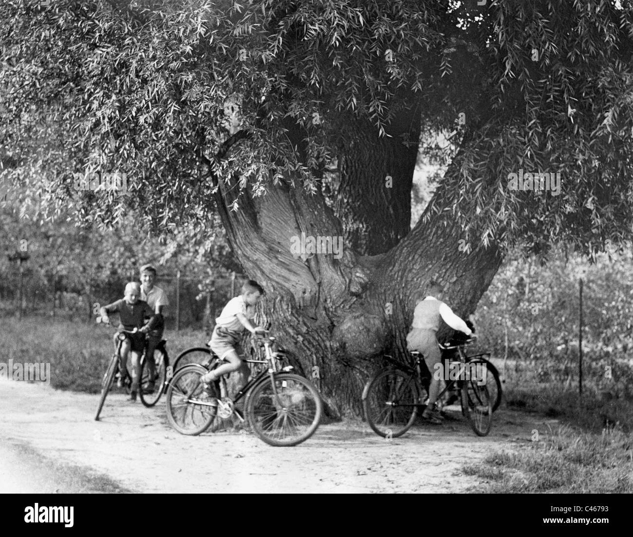 Children while cycling, 1937 Stock Photo