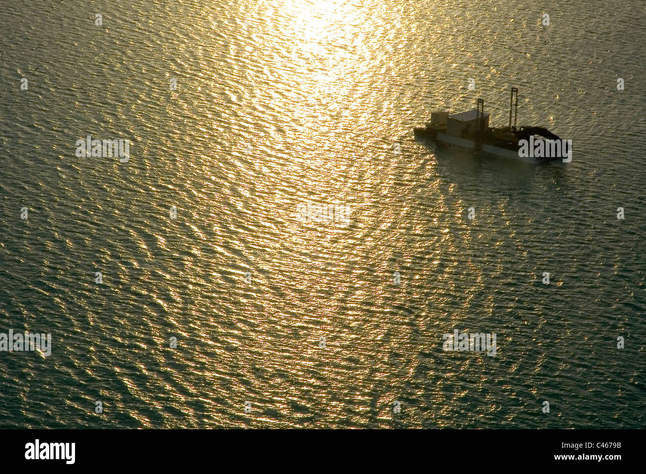 Aerial photograph of a crane on a barge in the southern basin of the Dead sea at sunrise Stock Photo